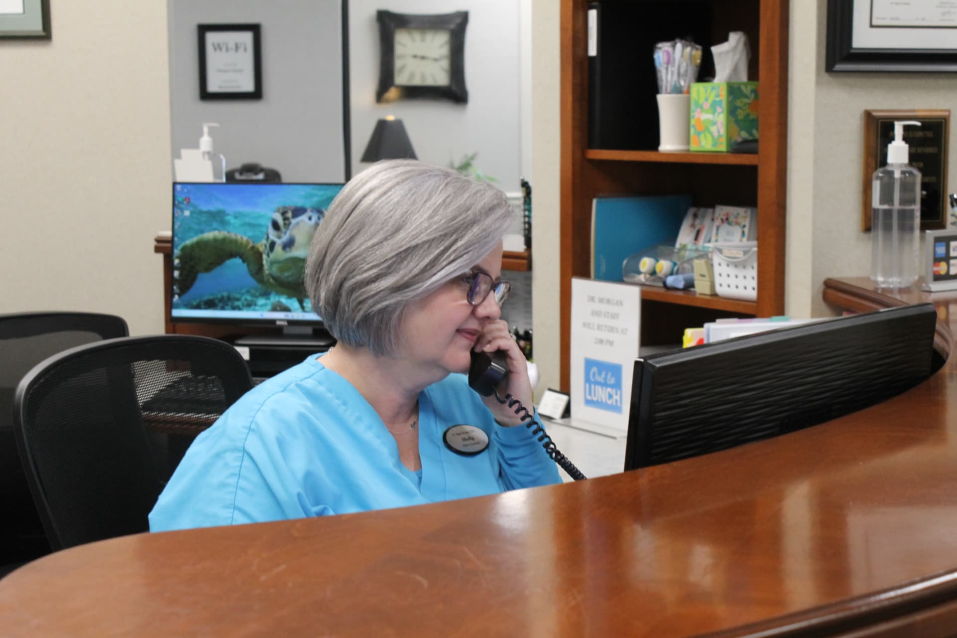 Shelly, our front desk coordinator, answering the phone at reception